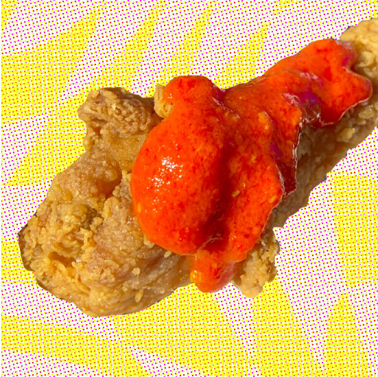 Bright red Cosmic Sass fermented chili hot sauce smothered on a crispy friend chicken wing. Yum!